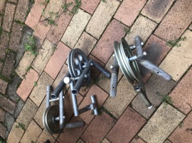 Tripod well head pulley assemblies