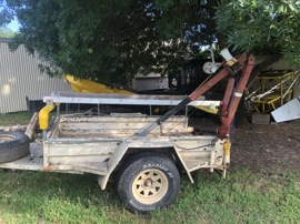 Trailer and hoist for difficult site boat launching.